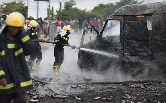 Firefighters trying to douse the embers of the fire that destroyed the van. Picture: EMMANUEL BOBBIE Firefighters trying to douse the embers of the fire that destroyed the van. Picture: EMMANUEL BOBBIE